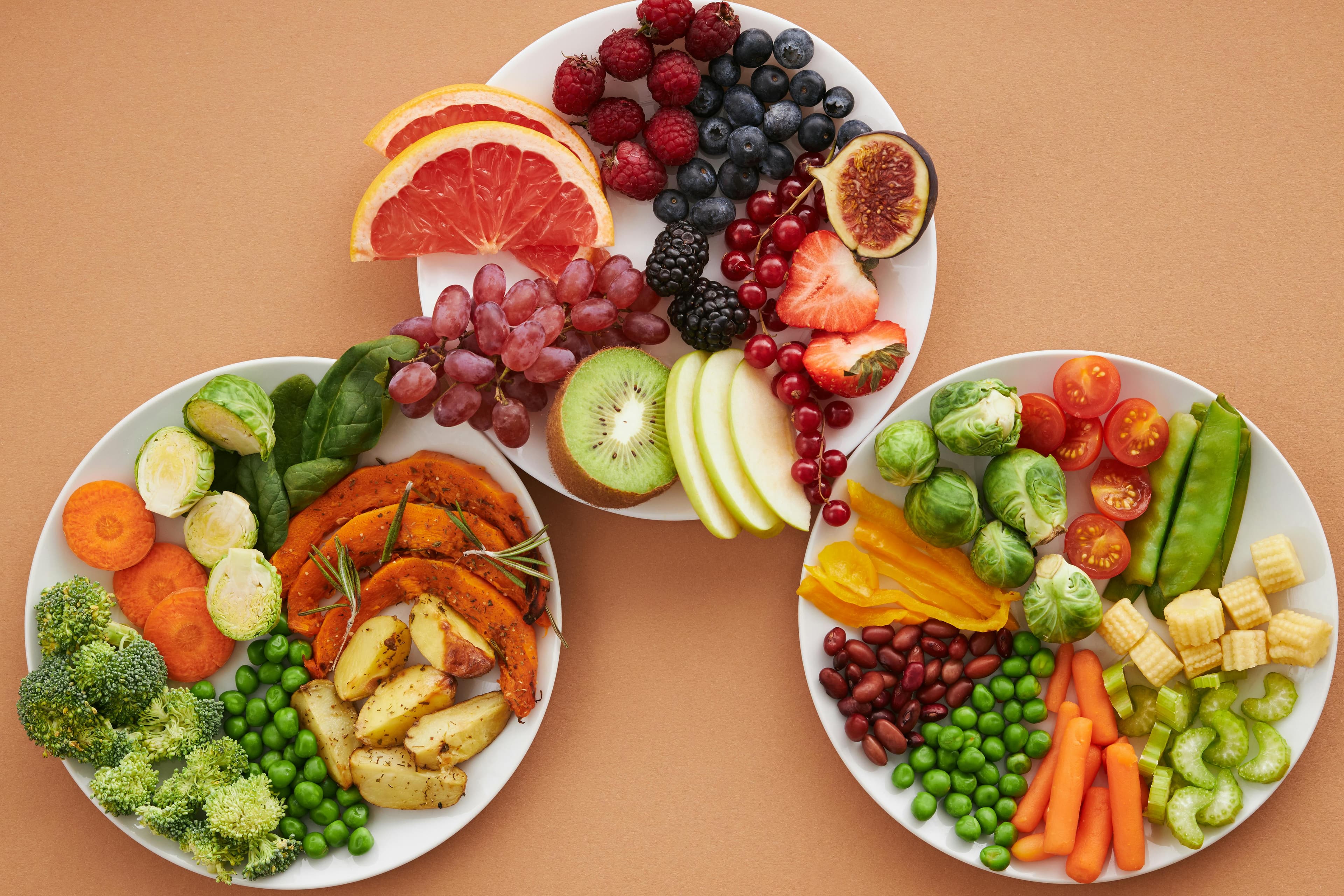 Happy woman enjoying a mindful meal with fresh, colorful foods