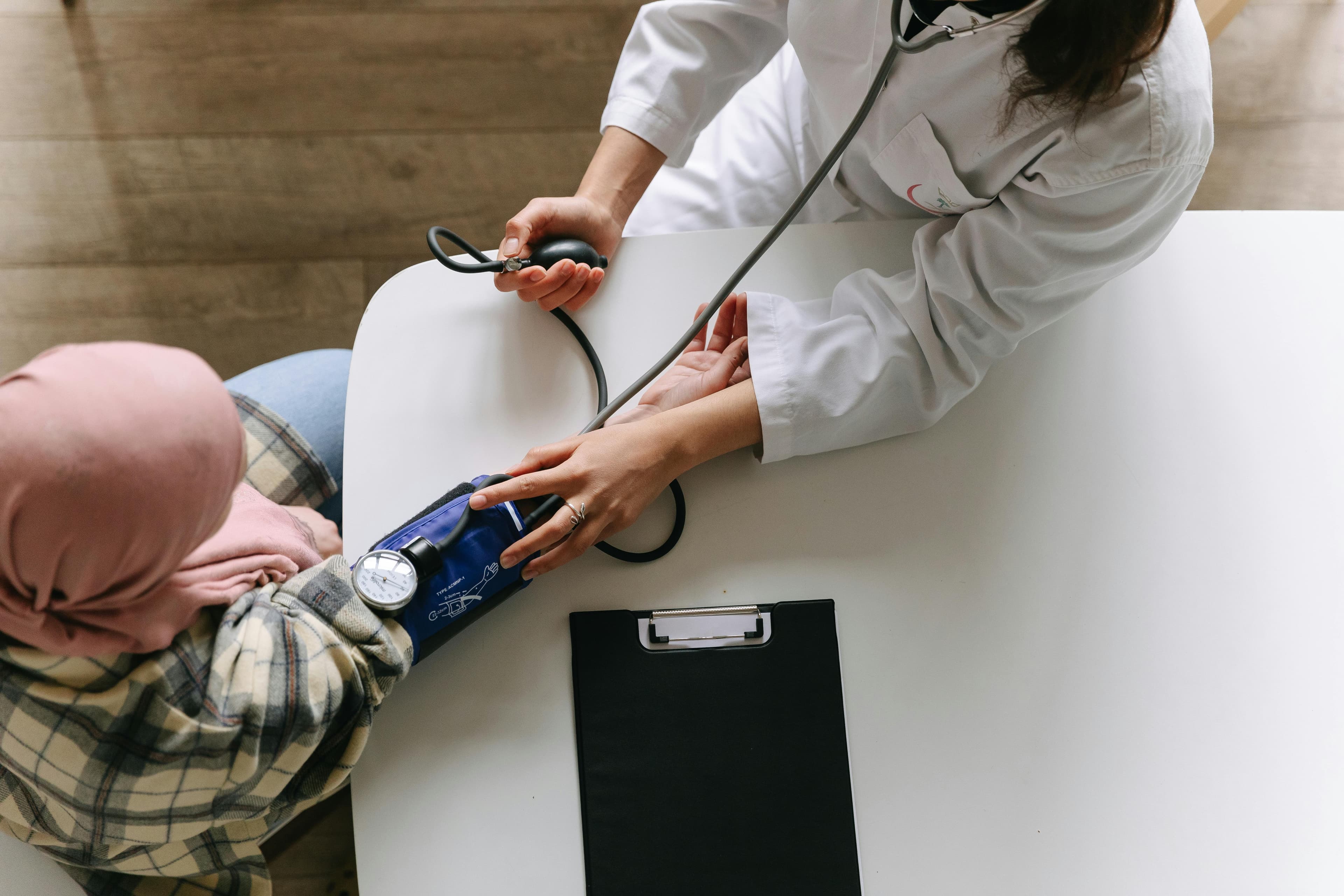 Medical professional discussing GLP-1 side effects with female patient, showing symptom timeline chart